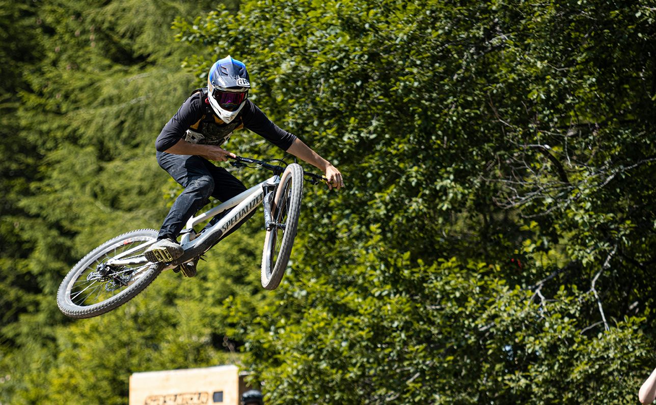 Group of riders practicing jumps at a mountain bike clinic