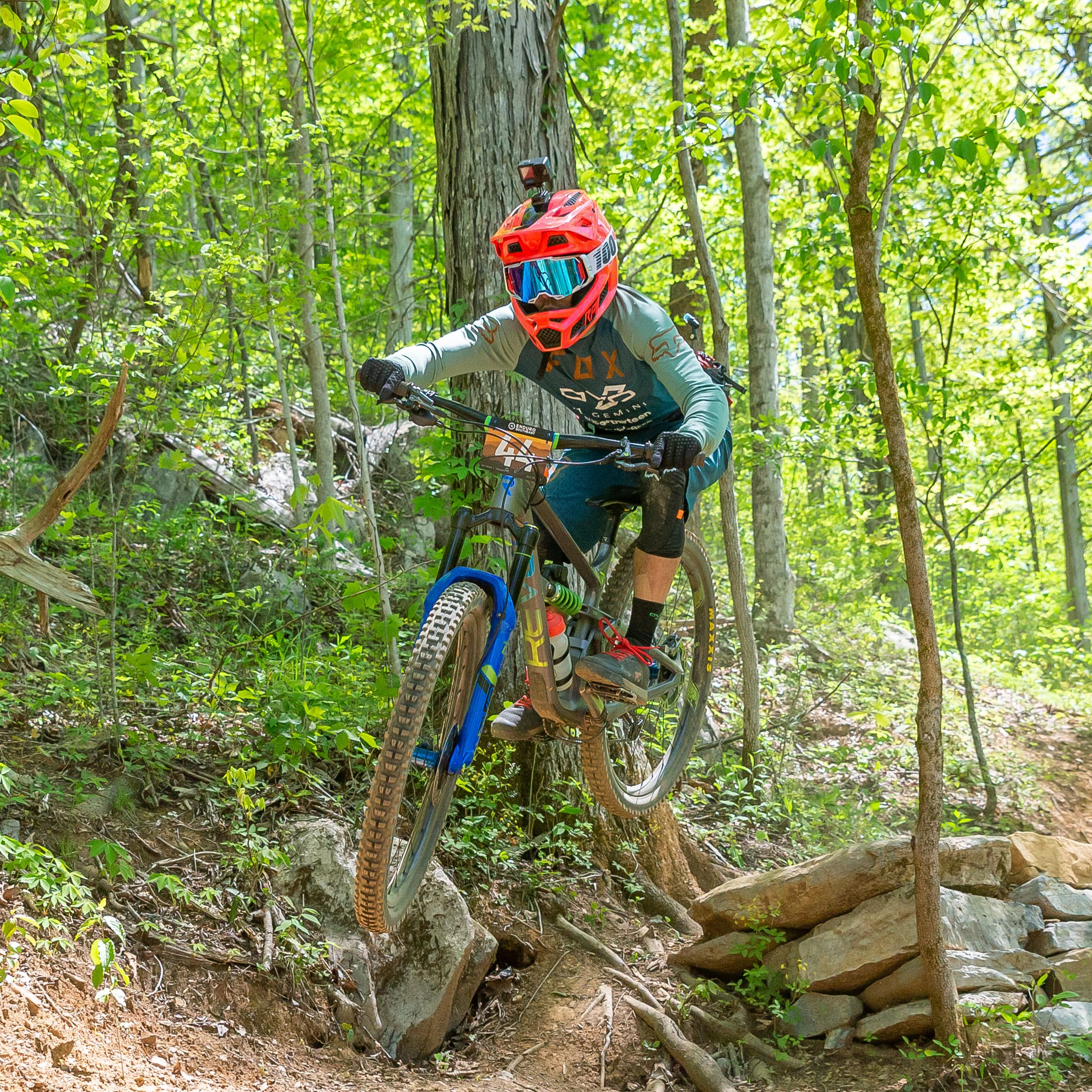 Instructor coaching a rider on a mountain bike trail
